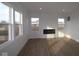 Bright living room featuring large windows, hardwood floors and modern fireplace at 6114 Paperbark Way, Indianapolis, IN 46259