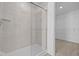 Modern bathroom with a tiled shower and glass door, next to the closet at 6114 Paperbark Way, Indianapolis, IN 46259