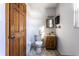 Simple bathroom with wood vanity, toilet, and tile flooring at 6137 E Southern Ave, Indianapolis, IN 46203