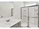 Clean bathroom with a glass-enclosed shower, white sink, and gray cabinets at 68 Sterling Pl, New Whiteland, IN 46184