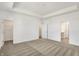 Carpeted primary bedroom featuring walk-in closet and ensuite bathroom entrances at 68 Sterling Pl, New Whiteland, IN 46184