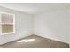 Empty bedroom features neutral carpet and a window providing natural light at 68 Sterling Pl, New Whiteland, IN 46184