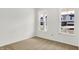 Bright bedroom with neutral carpet, white walls, and two large windows at 68 Sterling Pl, New Whiteland, IN 46184