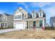 Charming two-story home with stone accents, large windows, and a two-car garage at 68 Sterling Pl, New Whiteland, IN 46184