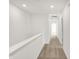 Second floor hallway featuring neutral carpet and bright white walls at 68 Sterling Pl, New Whiteland, IN 46184