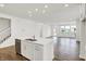 Island kitchen with stainless steel dishwasher and expansive hardwood flooring at 68 Sterling Pl, New Whiteland, IN 46184