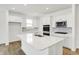 Bright kitchen features stainless steel appliances, white cabinets, and quartz countertops at 68 Sterling Pl, New Whiteland, IN 46184