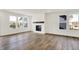 Living room with large windows and a modern fireplace with wooden mantel at 68 Sterling Pl, New Whiteland, IN 46184