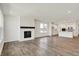 Spacious living room with modern fireplace opens to kitchen and dining at 68 Sterling Pl, New Whiteland, IN 46184