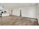 Open-concept living room with hardwood floors connects to kitchen at 68 Sterling Pl, New Whiteland, IN 46184