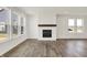 Open living room with modern fireplace, hardwood floors, and large windows at 68 Sterling Pl, New Whiteland, IN 46184