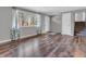 Inviting living room showcasing wood floors, stairs, and a view of the outdoors through a large window at 9829 Chambray Dr, Indianapolis, IN 46280