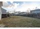 Large grassy backyard featuring a wood fence and views of nearby homes at 13834 Keams Dr, Fishers, IN 46038