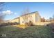 Large backyard with a wooden fence, green grass, and a wooden deck at 13834 Keams Dr, Fishers, IN 46038