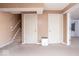 View of basement featuring neutral carpeting, stairs and two white doors at 13834 Keams Dr, Fishers, IN 46038