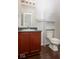 Bathroom features a single sink with a wood vanity and a toilet with built-in shelving at 13834 Keams Dr, Fishers, IN 46038