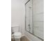 Bathroom featuring a toilet next to a glass-enclosed bathtub and shower at 13834 Keams Dr, Fishers, IN 46038