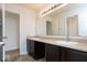 Bathroom featuring a double vanity with dark cabinets and a large mirror at 13834 Keams Dr, Fishers, IN 46038