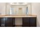 Bathroom featuring a double vanity with dark cabinets and a large mirror at 13834 Keams Dr, Fishers, IN 46038