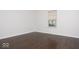 Empty bedroom showcasing light walls, a window for natural light, and hardwood floors at 13834 Keams Dr, Fishers, IN 46038