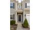 Inviting front entrance with a black front door, decorative plants, and neutral siding and trim at 13834 Keams Dr, Fishers, IN 46038