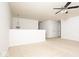 Well-lit living room features neutral walls and carpet, along with a contemporary ceiling fan at 13834 Keams Dr, Fishers, IN 46038