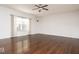 Expansive living room featuring hardwood floors, a ceiling fan, and large windows at 13834 Keams Dr, Fishers, IN 46038