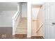 Carpeted staircase featuring white banisters and dark wood floors at the base of the stairs at 13834 Keams Dr, Fishers, IN 46038