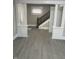 Inviting living room featuring stylish grey floors, decorative columns, and a glimpse of the staircase at 401 N Chester Ave, Indianapolis, IN 46201