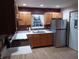 Bright kitchen with oak cabinets, stainless steel appliances, and brick backsplash at 502 E 9Th St, Sheridan, IN 46069