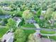 An aerial view of homes shows the neighborhood streets and homes with mature trees and well maintained lawns at 56 Hadley Woodland St, Mooresville, IN 46158