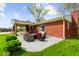 A relaxing patio with outdoor seating and a view of the lush backyard and red brick home at 56 Hadley Woodland St, Mooresville, IN 46158