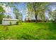 Large, lush backyard features a shed, large trees, and well-maintained lawn at 56 Hadley Woodland St, Mooresville, IN 46158