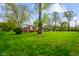 Charming single-story brick home with a lush green lawn and mature trees in a tranquil setting at 56 Hadley Woodland St, Mooresville, IN 46158