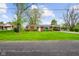 A single-story red brick home with an attached carport and a spacious green lawn at 56 Hadley Woodland St, Mooresville, IN 46158