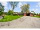 A single-story red brick house featuring an attached carport and a wide driveway at 56 Hadley Woodland St, Mooresville, IN 46158