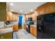 Eat-in kitchen featuring oak cabinets, black appliances, and tile flooring at 56 Hadley Woodland St, Mooresville, IN 46158