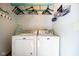 Convenient laundry room featuring a washer, dryer, and storage space at 56 Hadley Woodland St, Mooresville, IN 46158