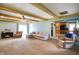 Cozy living room with beamed ceilings, fireplace, and access to the kitchen at 56 Hadley Woodland St, Mooresville, IN 46158