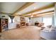 Comfortable living room features a fireplace, beamed ceilings, and lots of seating at 56 Hadley Woodland St, Mooresville, IN 46158