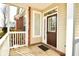 Dark brown front door with sidelights and white trim at 5711 Polk Dr, Noblesville, IN 46062