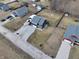 This aerial view displays the 2-story home with a gravel drive and nearby houses at 6374 W Friends Wy Ct, Paragon, IN 46166