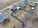 An aerial view shows the backyard of this home has a wooden fence and fire pit at 6374 W Friends Wy Ct, Paragon, IN 46166