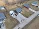 An aerial view shows this two-story home with an ample yard and a detached garage at 6374 W Friends Wy Ct, Paragon, IN 46166