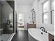 Bright bathroom featuring a soaking tub, glass shower, and wood vanity at 17368 Pinellas Ave, Westfield, IN 46074