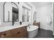 Bright bathroom featuring double sinks, a freestanding tub, and modern fixtures for a luxurious feel at 17368 Pinellas Ave, Westfield, IN 46074