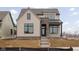 Charming two-story home with brick accents, light brown siding and steps leading to a covered front porch at 17368 Pinellas Ave, Westfield, IN 46074