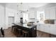 Modern kitchen with white cabinets, a gray island with seating, and stainless steel appliances at 17368 Pinellas Ave, Westfield, IN 46074