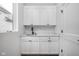 Laundry room with modern white cabinets, sink and dark hardware at 17368 Pinellas Ave, Westfield, IN 46074
