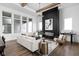 Bright, open living room featuring a black slat wall fireplace, modern lighting, and large windows at 17368 Pinellas Ave, Westfield, IN 46074